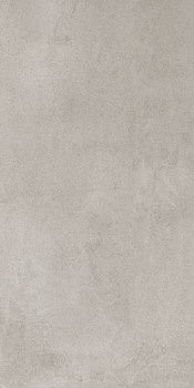 Matte silver-gray porcelain tile with a soft bush-hammered texture, evoking timeless industrial elegance and serene minimalist charm.