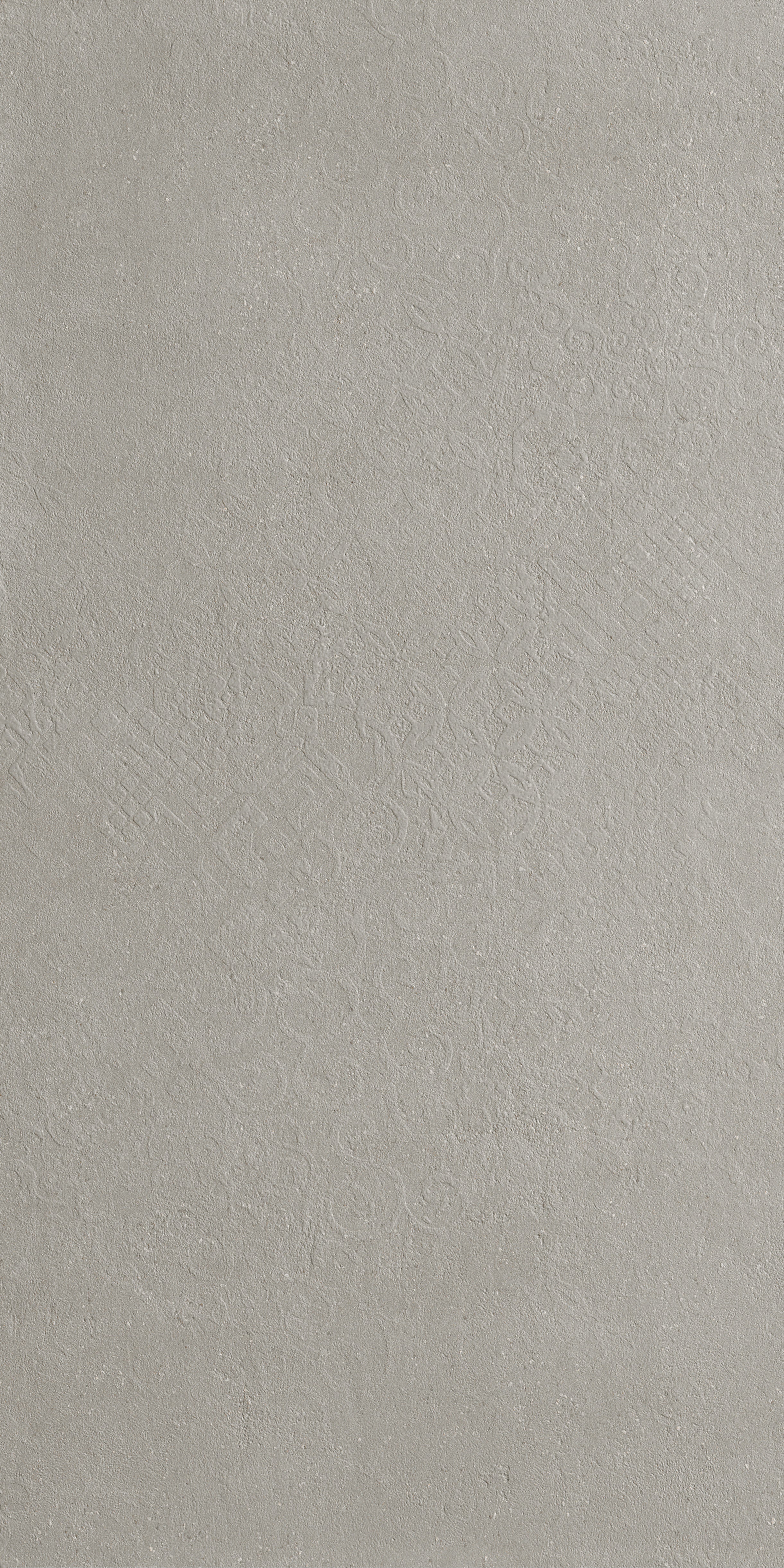 Textured matte porcelain tile in deep gray with luminous reflections and delicate deco patterns, evoking industrial elegance and refined minimalism.