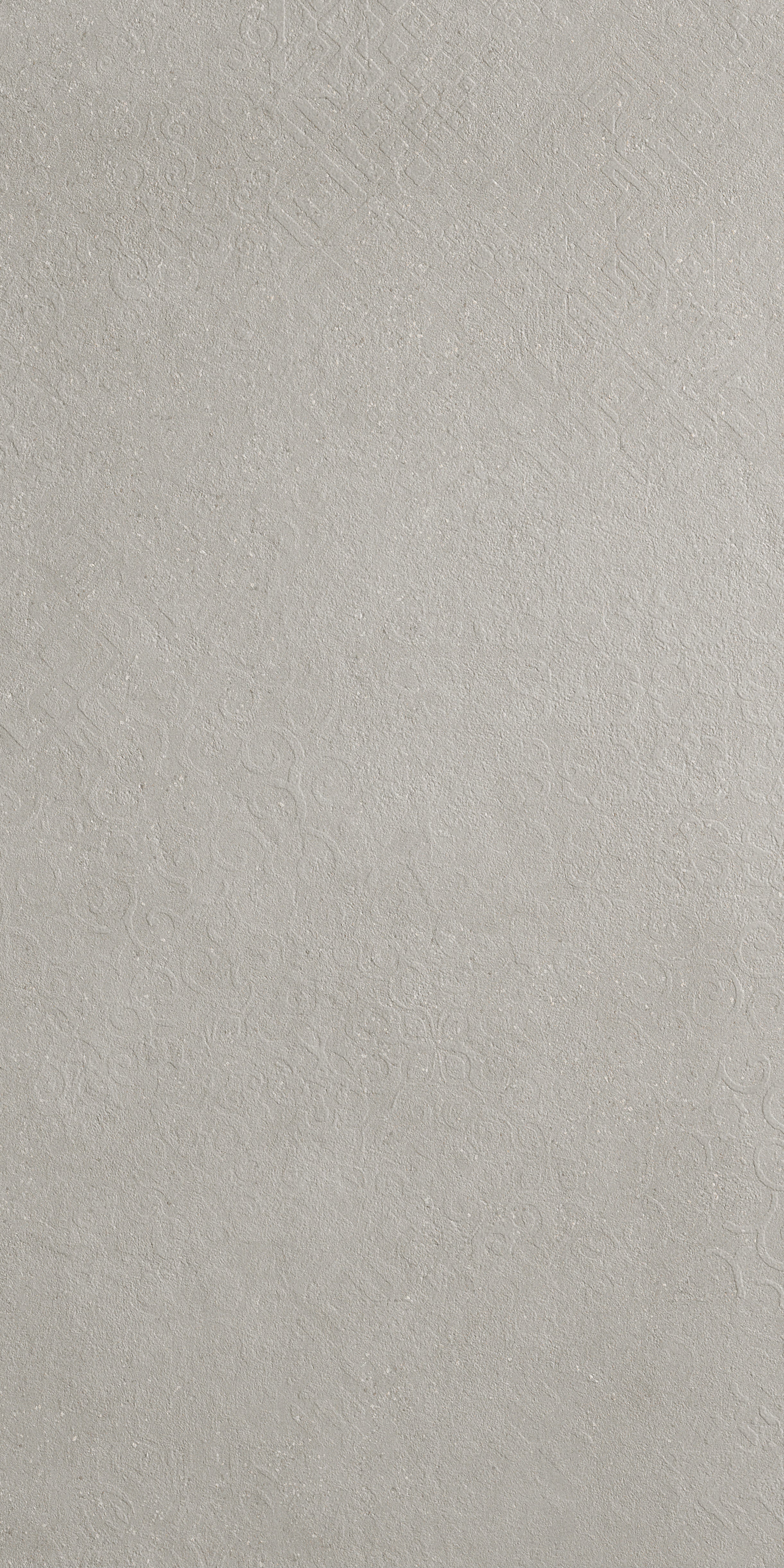 Textured matte porcelain tile in deep gray with luminous reflections and delicate deco patterns, evoking industrial elegance and refined minimalism.