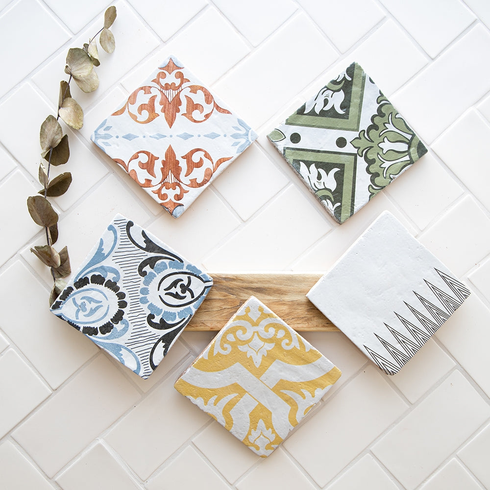 handmade glazed terracotta tile display with five different matching patterns distributed by surface group international and produced by marble systems